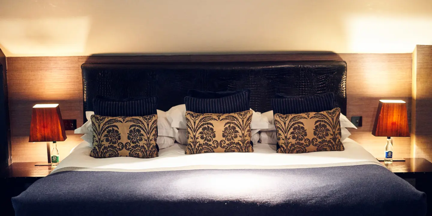 A king sized bed adorned with decorated pillows.