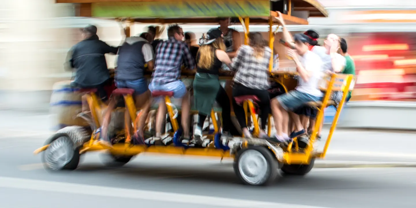 A group of individuals riding on a cart.
