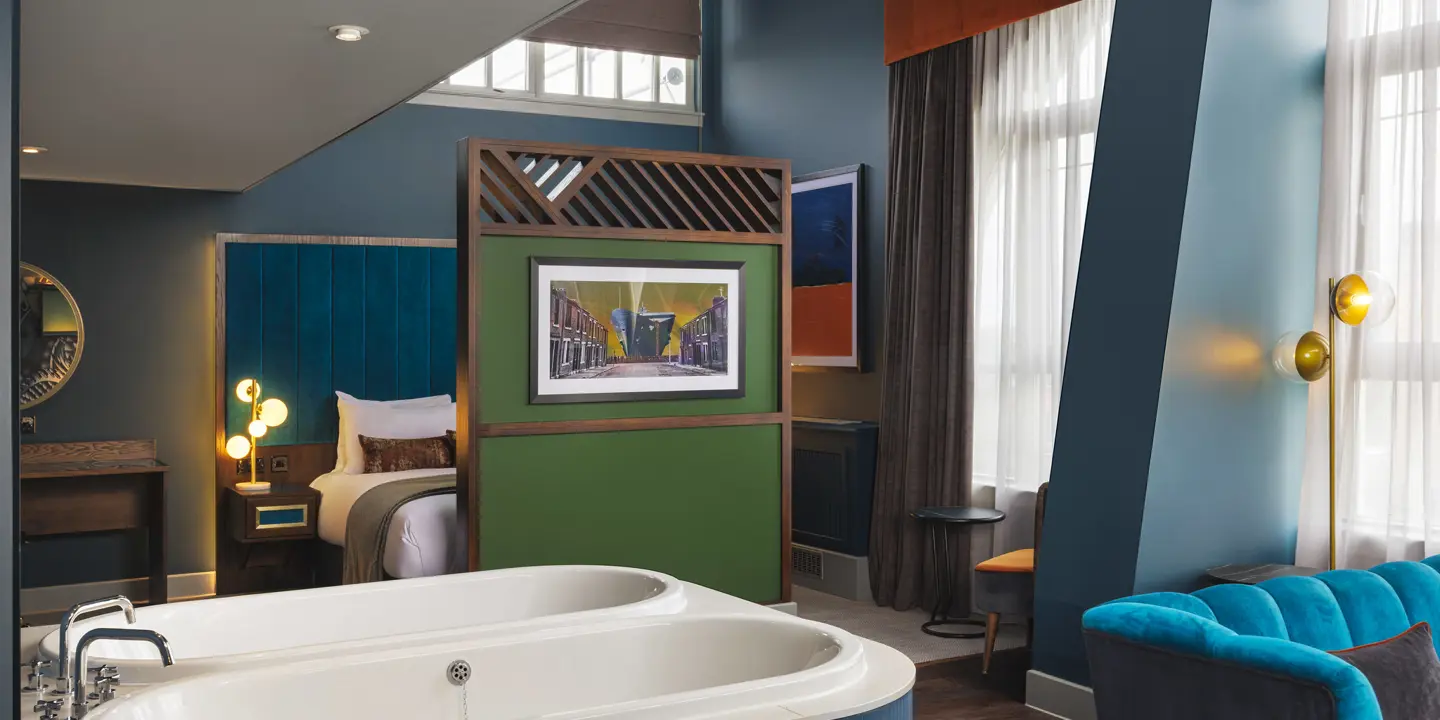 A spacious room with a large bed and two bathtubs.