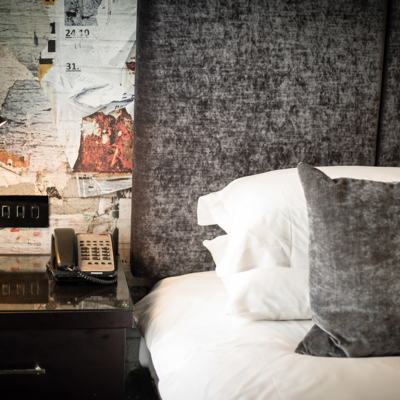 Hotel room featuring a telephone and a comfortable bed.