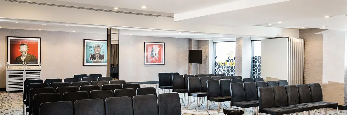 An interior space adorned with sleek black chairs and tables.