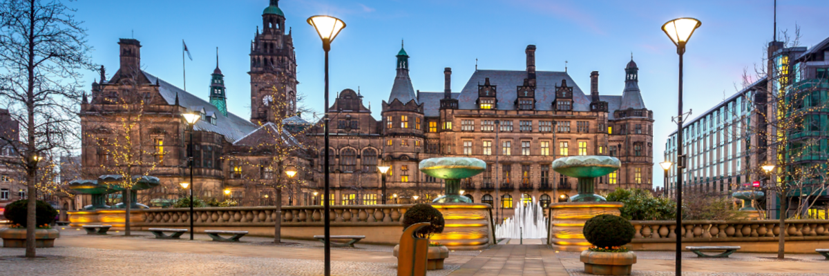 A large building with a fountain in front.