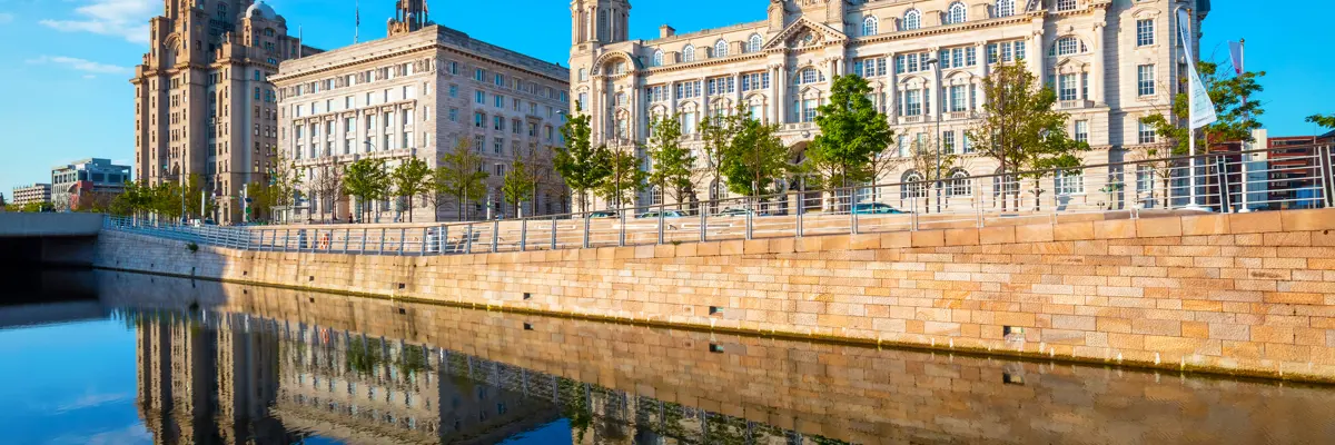 A spacious building situated alongside a serene body of water.