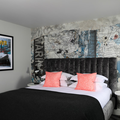 Bedroom featuring a comfortable bed and an elegant wall painting.