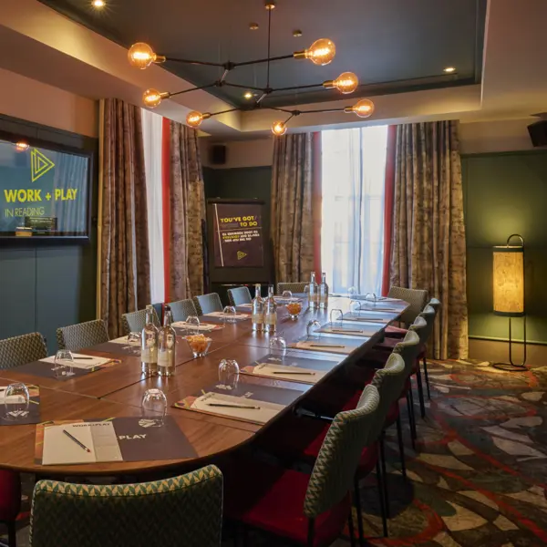 A beautiful meeting room with place settings, ready for business